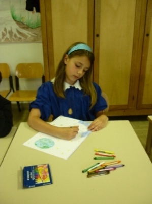 bambina disegna con le matite a cera